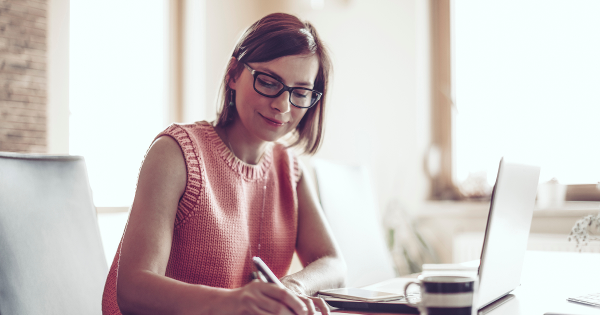 Small Business Owner Writing In Journal