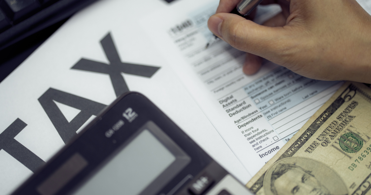 Person filing out 1040 tax form. Social Security.